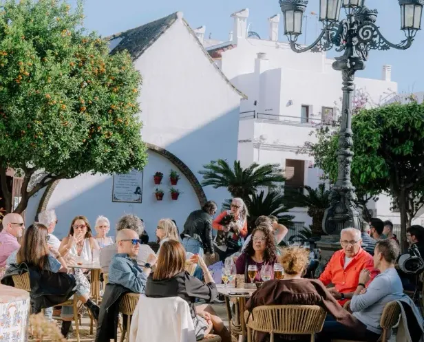 Guests enjoying food and drinks on the terrace at Mercado Santa Ana in Estepona town centre
